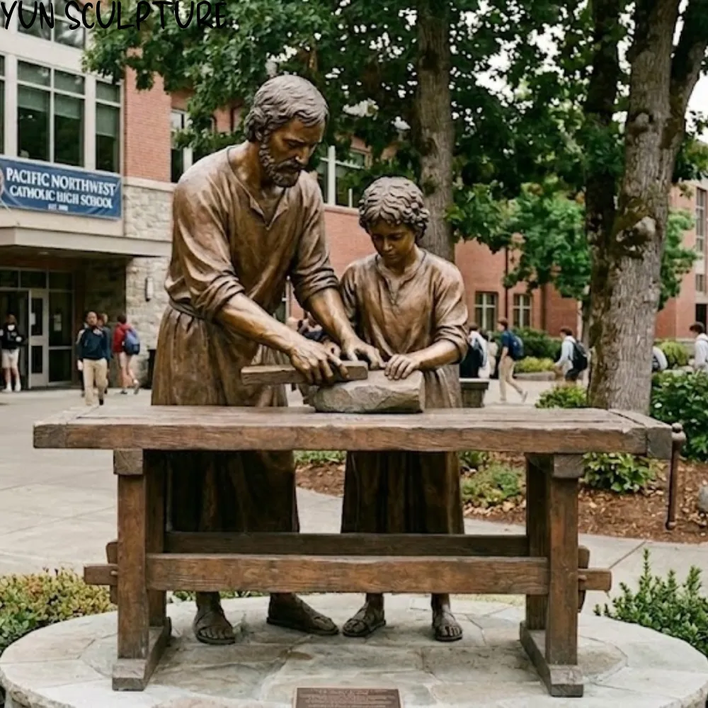 Dynamic two-figure bronze sculpture of St. Joseph guiding Jesus's hands on a chisel, featuring professional armature for permanent outdoor installation in a church or school courtyard.