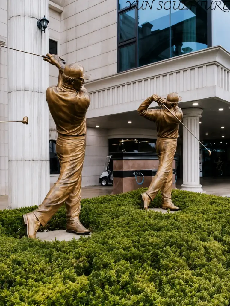 A bronze golfer statue in a dynamic follow-through pose. This permanent metal artwork represents the "memory made permanent" philosophy for world-class golf course garden design.
