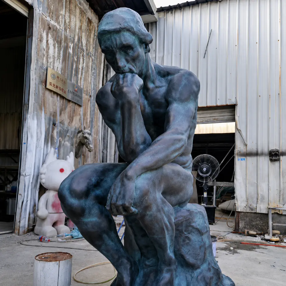 Close-up of a bronze Thinker replica highlighting the intricate muscle definition and facial expression. The lost-wax process captures extreme detail fidelity in the structural metal casting, as seen in this foundry-direct piece.