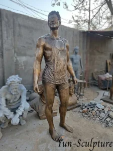A life-size (170-185 cm) custom bronze portrait statue of a man in casual attire and sunglasses, standing in the Yun Sculpture foundry. This piece exemplifies our high-fidelity likeness commissions and custom pose figures, crafted within 30-50 working days using professional lost-wax casting.