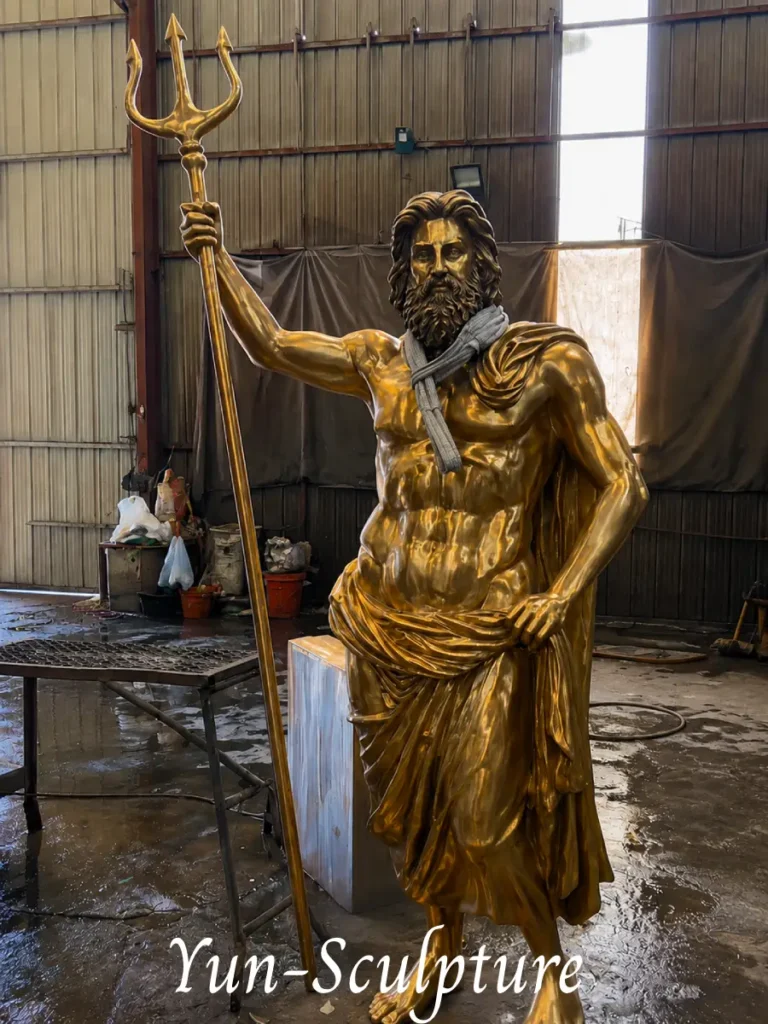 A heroic-scale cast bronze Poseidon statue with a trident. As detailed in the text, bronze provides the necessary structural integrity for his projecting trident, making it the perfect focal point for pools, fountains, or waterfront estates.