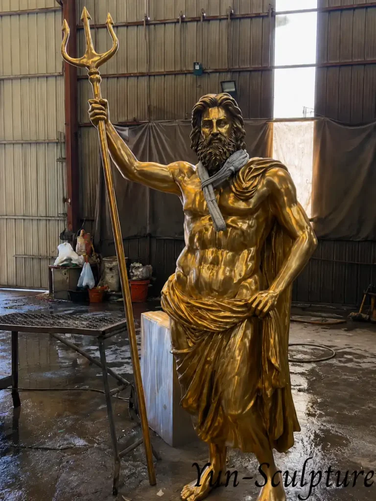 A life-size polished gold bronze statue of the Greek God Poseidon holding a trident. Representing the Greek tradition of "god-as-force," this physically powerful sculpture is designed for estate entrances or large garden axis points to communicate authority and justice.