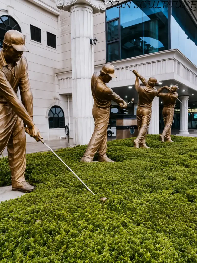 Multiple bronze golf action statues positioned along a stone building entrance, demonstrating how high-end metal art becomes an inseparable part of a club’s architecture.