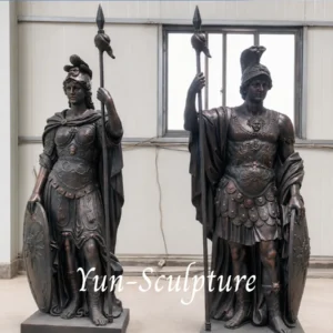 A pair of heroic-scale cast bronze statues of Athena and Ares in full classical armor with spears and shields. These life-size figures are designed for institutional entrances, such as law firms or university buildings, to communicate intellectual seriousness and permanent authority.