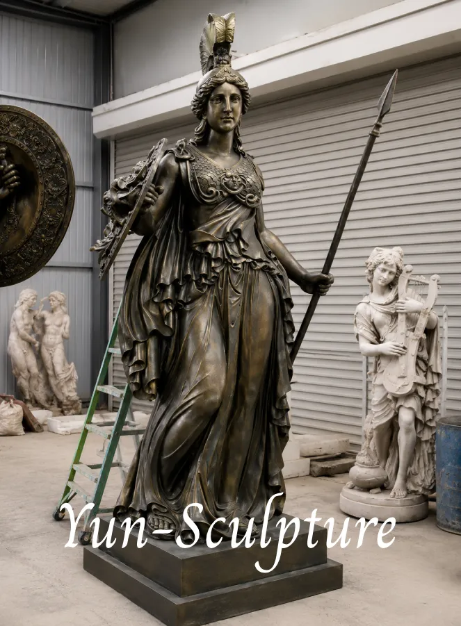 A majestic life-size bronze Athena statue in full armor with spear and shield, standing in our foundry. While the Athena Lemnia represents wisdom at rest for private studies, this martial version honors Athena’s strategic command, making it a perfect architectural landmark for academic institutions or law firms.
