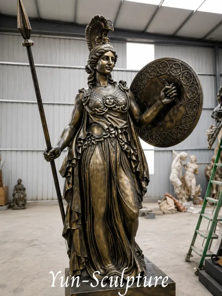 Life-size bronze Athena statue in full classical armor with spear and shield. Communicating intellectual seriousness and strategy, it is the correct choice for law firms, libraries, or academic institutions.