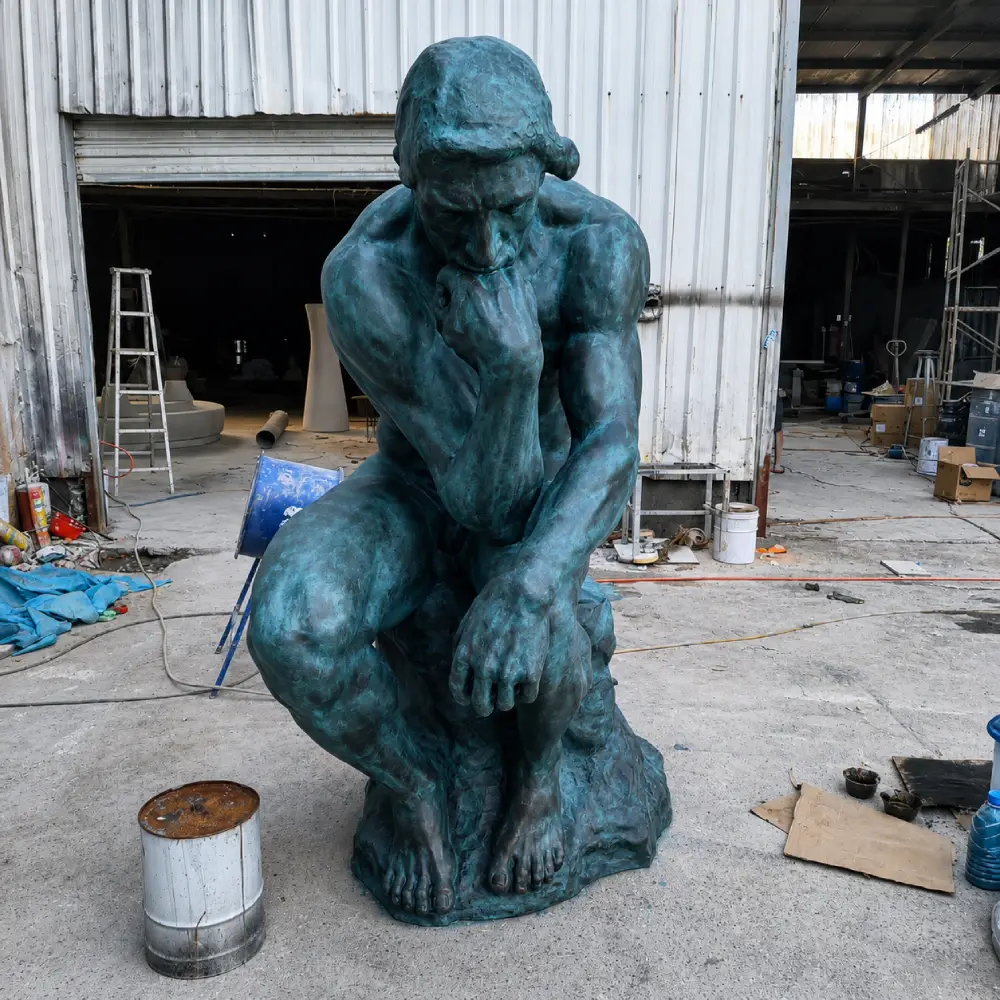 A front view of a life-size bronze Thinker statue cast using the traditional lost-wax method. This solid metal sculpture contains over 85% copper, ensuring a high-quality finish and museum-grade durability.