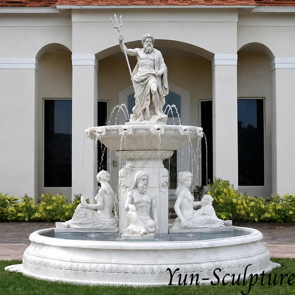 A monumental three-tier white marble fountain featuring the Greek God Poseidon at the summit, trident in hand, and seated mythological figures at the base. Installed at a luxury estate entrance, this hand-carved masterpiece communicates the "sovereign force" and ancient authority of Poseidon over water features, as described in our placement guide.