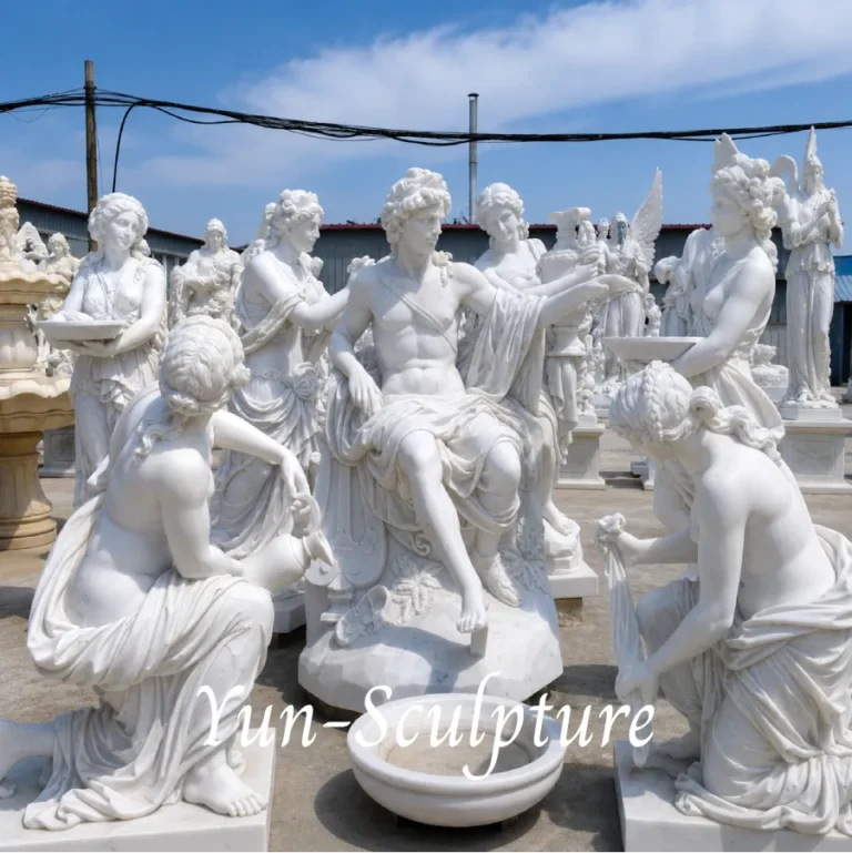 A monumental group of hand-carved natural white marble sculptures featuring Apollo and nymphs. Following our structural principles for garden installation, these white marble figures require elevation on a 40-80cm pedestal and placement against a dark foliage background to achieve the "authority" and "contrast" described in our guide.