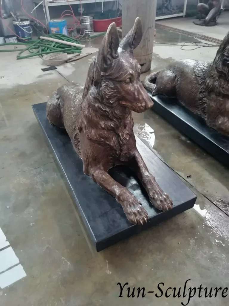 A detailed reclining bronze German Shepherd statue on a black marble base. This custom living portrait commission offers a permanent and luminous presence for pet owners, designed to transition from a tribute of appreciation to a lasting memorial.
