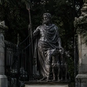 A majestic life-size cast bronze statue of Hades (Pluto) with his three-headed dog Cerberus, guarding a formal garden gate. Finished in a deep antique black patina, this classical figure embodies the "impersonal sovereignty of natural law" as described in our guide, distinguishing the true Greek tradition from contemporary fantasy designs.