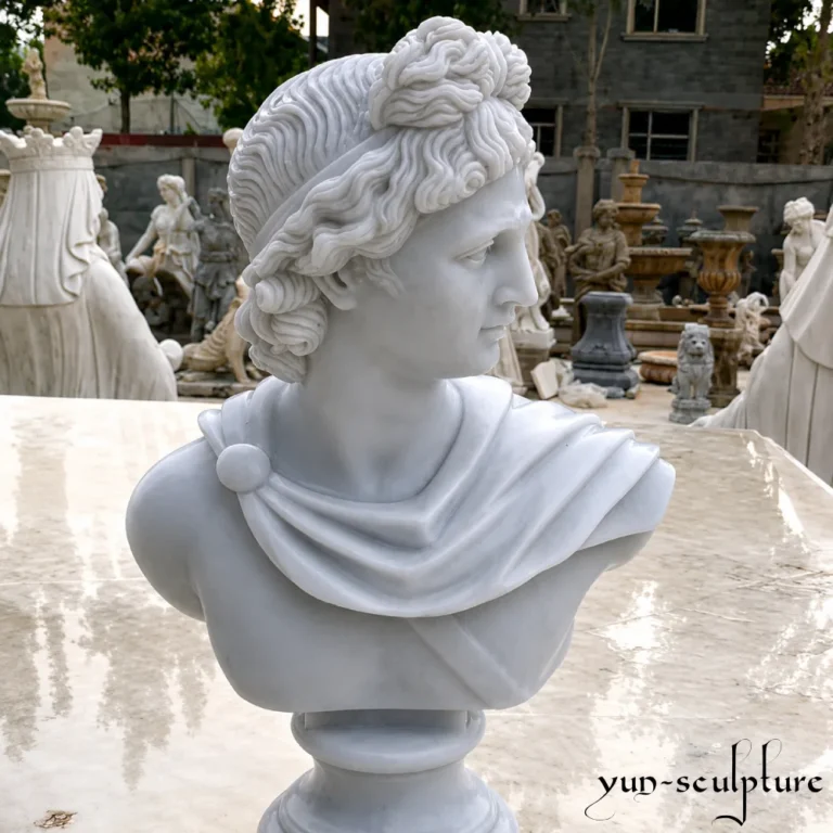 A hand-carved natural white marble bust of Apollo, following the iconic Belvedere type with elaborately curled hair and an idealized youthful expression. This classical sculpture represents harmonious perfection and ordered intelligence, making it a sophisticated focal point for private libraries, music rooms, or spa terraces as described in our guide.