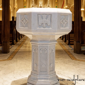 A dignified hand-carved natural white marble ambo for a Catholic church sanctuary, featuring a Holy Spirit dove relief and Gothic architectural details. This heavy stone pulpit serves as the sacred place for reading the Gospel, designed to provide a permanent and prestigious presence in traditional church interiors.