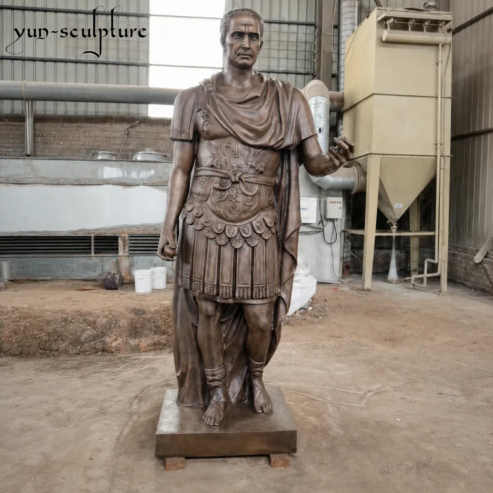 A majestic life-size cast bronze statue of Julius Caesar in Roman military armor, standing at the Yun-Sculpture foundry. Engineered for permanent outdoor installation, this genuine bronze figure is naturally weather-resistant and only requires occasional microcrystalline wax application to maintain its premium finish for decades.