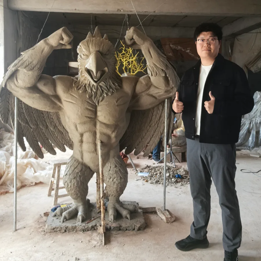 Clay model of the muscular bluebird mascot sculpture during the sculpting stage.