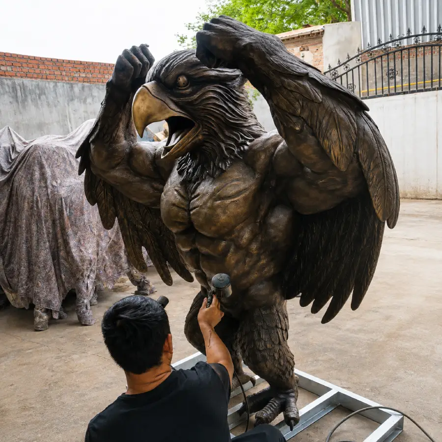Final patina adjustment and surface finishing on the custom bronze bluebird sculpture.