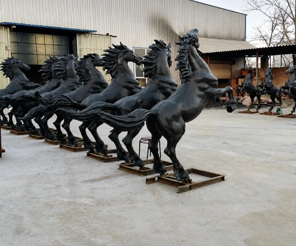 Finished bronze horse sculptures at the Yun Sculpture factory during production and final inspection.