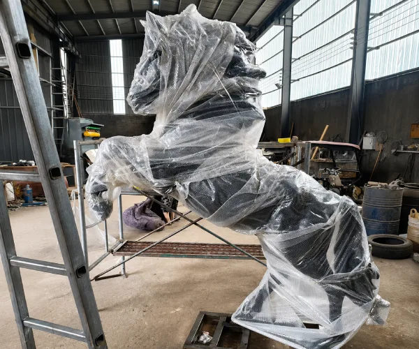 Custom bronze horse sculpture wrapped with protective material before export packing for shipment to Kuwait.