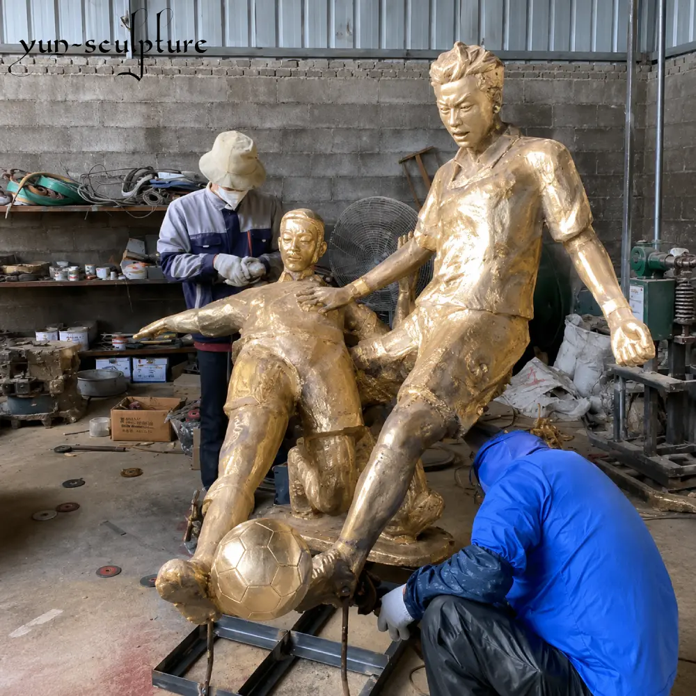 Skilled artisans at the Yun Sculpture workshop finishing a custom lost-wax cast bronze football player statue. This 1:1 scale model demonstrates our precision in capturing action poses and uniform details before applying the final patina.