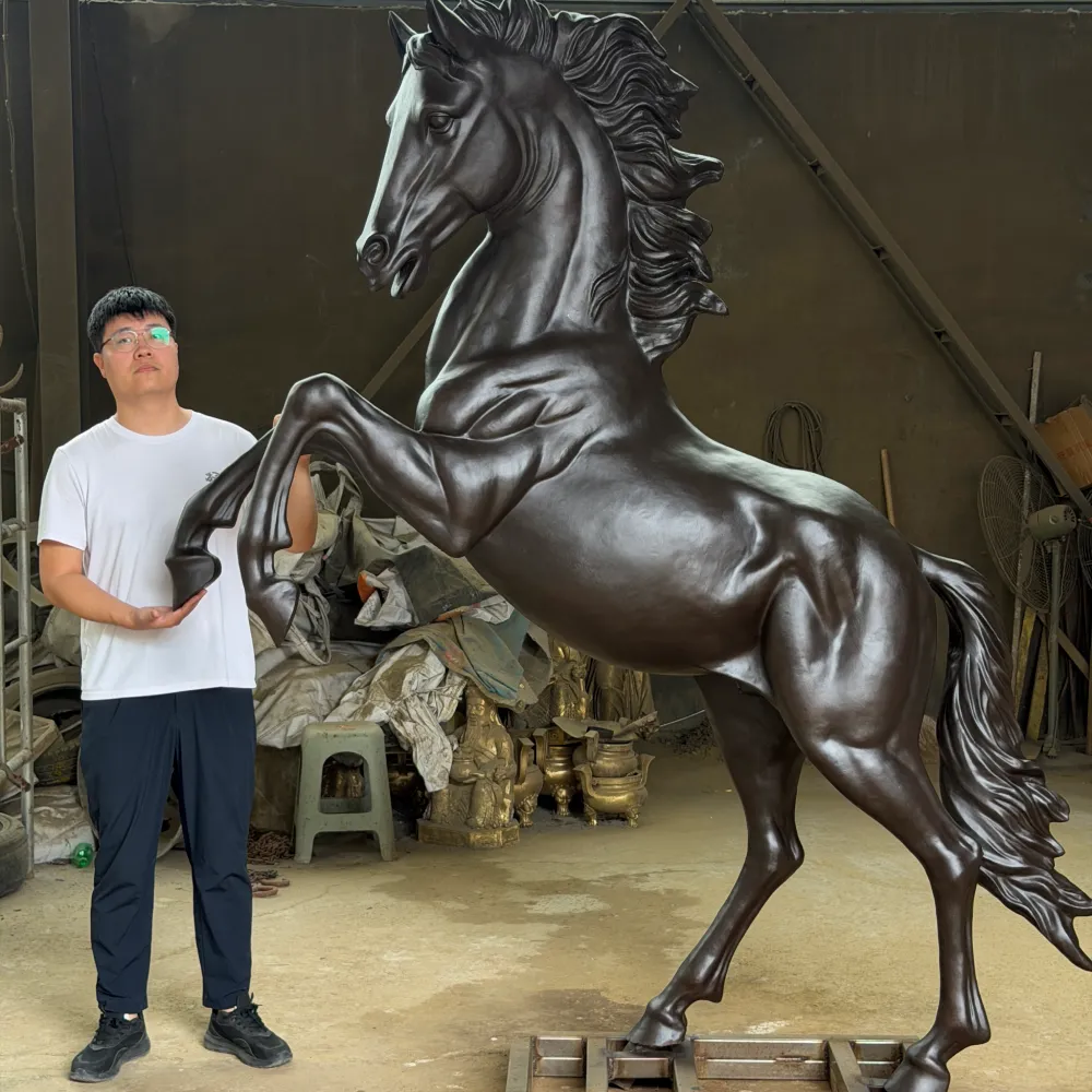 Donghui Zhang, Owner of Yun Sculpture, standing beside the finished bronze rearing horse sculpture for scale and proportion reference.