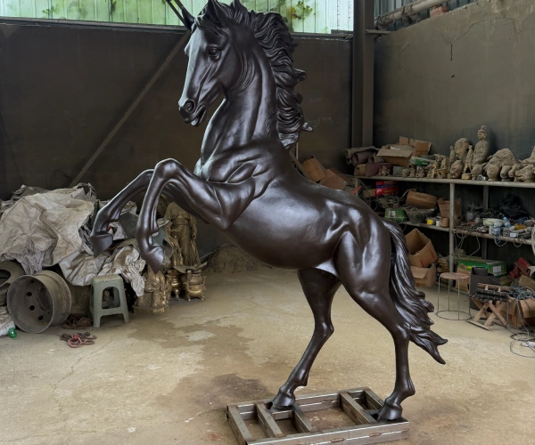 Finished rearing bronze horse sculpture showing balanced proportions, natural posture, defined anatomy and completed patina.
