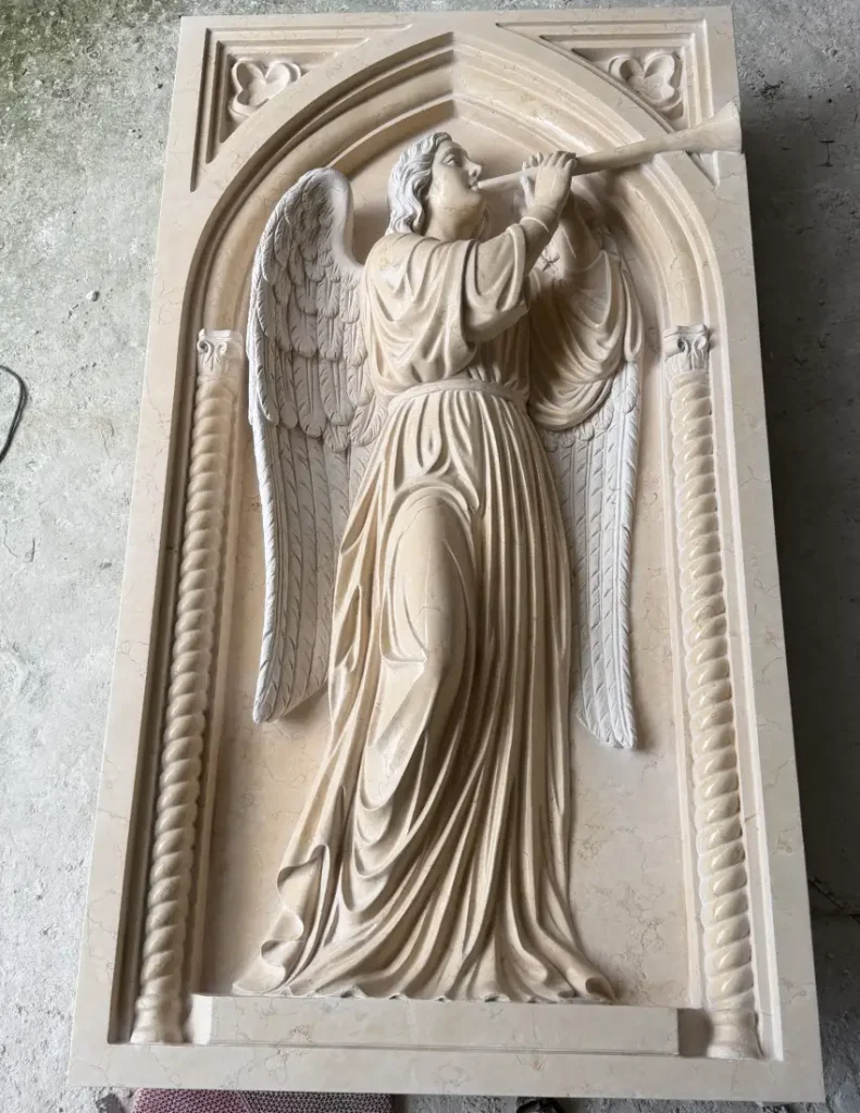 Finished St. Gabriel marble relief with raised horn and flowing garments for a U.S. church project