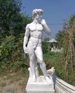 A life-size, hand-carved natural white marble replica of Michelangelo’s David standing in our outdoor workshop. Following the original’s precise measurements, this high-fidelity sculpture represents the premier category of David replicas, distinct from common molded resin versions as described in our buyer's guide.