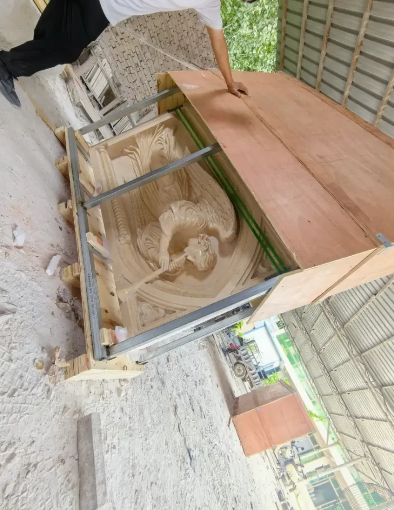 Protective packing detail showing a marble relief secured with steel framing and wooden panels
