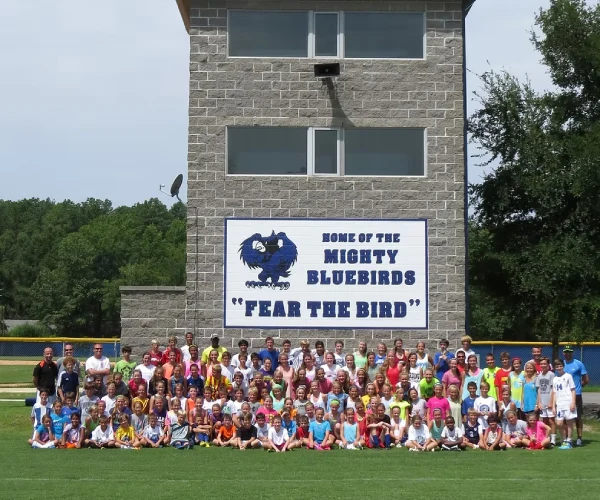 Group photo at the client’s site in Little Rock, Arkansas, featuring the Mighty Bluebirds “Fear the Bird” sign.