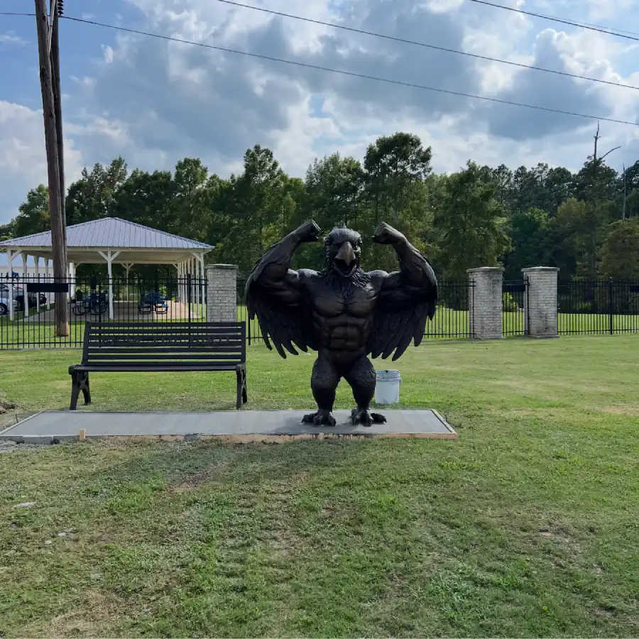 Muscular bronze bluebird sculpture installed outdoors at the client’s site in Little Rock, Arkansas.