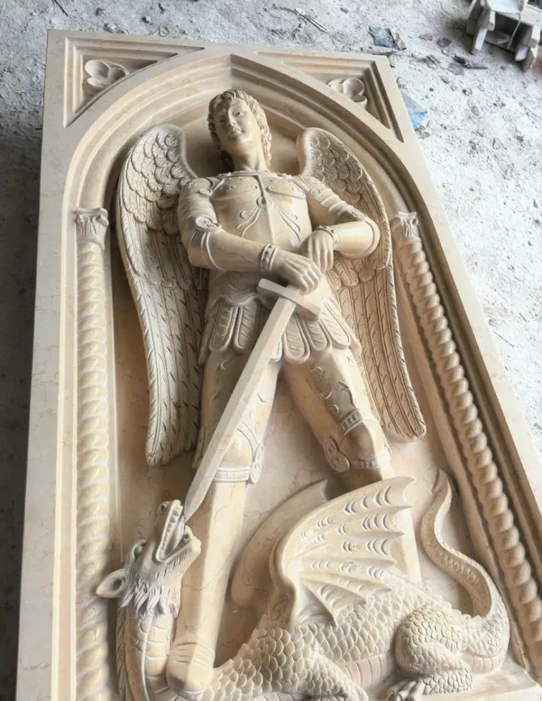 Polished St. Michael marble relief showing the natural stone color and finished surface