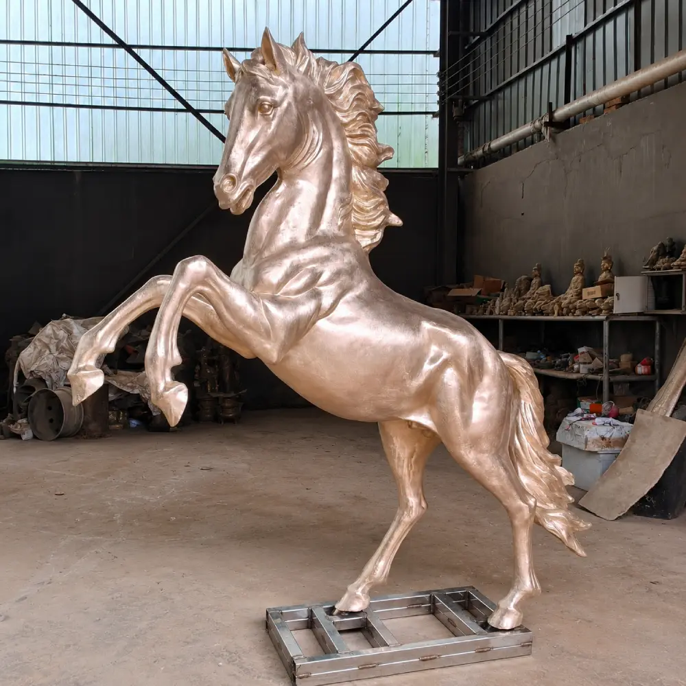 Newly cast bronze rearing horse sculpture before patina, showing the completed bronze form and surface details.
