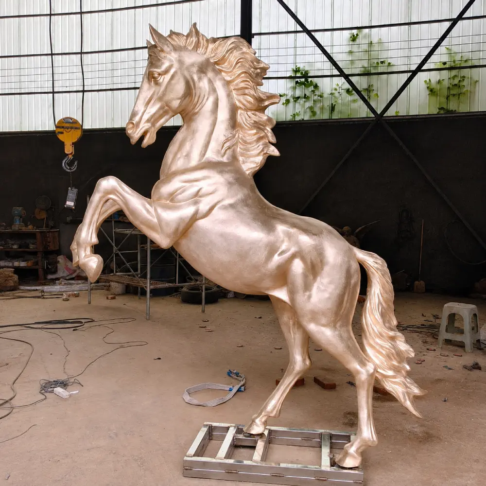 Rear three-quarter view of the bronze horse sculpture before patina, showing the hindquarters, tail and overall balance of the pose.