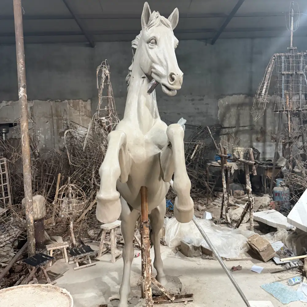 Front view of the rearing horse sculpture clay model showing the chest, raised front legs and head proportions.