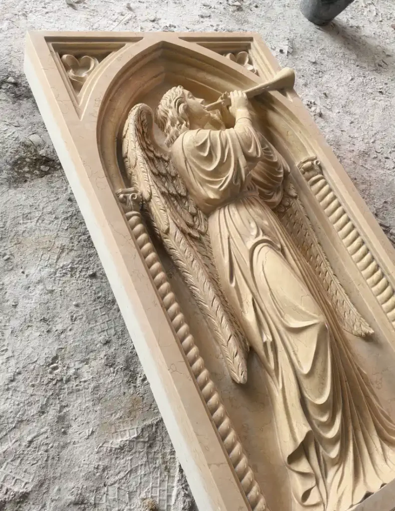 Finished St. Gabriel marble relief showing polished garments, wings and architectural details