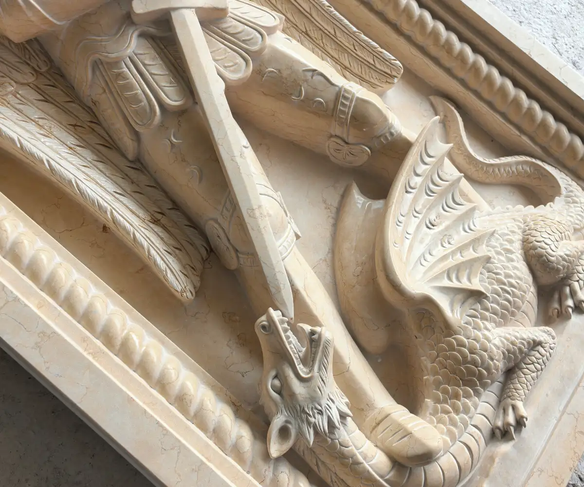 Polished detail of the St. Michael marble relief showing the sword, armor and dragon