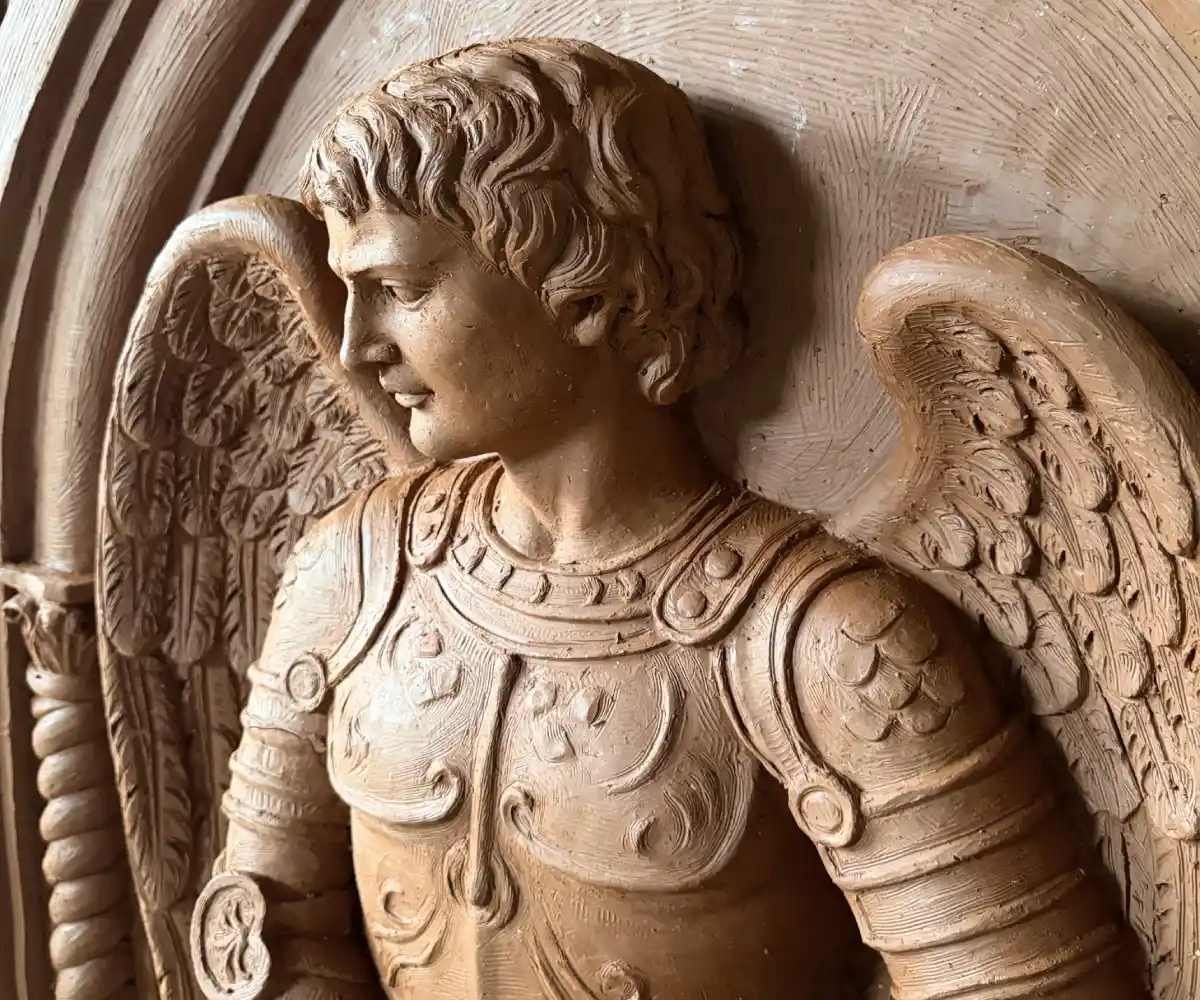 Close-up detail of the St. Michael sculptural model showing the face, armor and wings