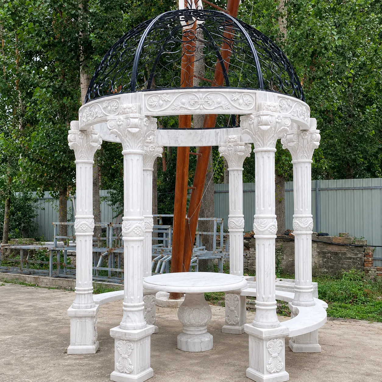 Compact round marble gazebo with a curved bench and open top outdoors