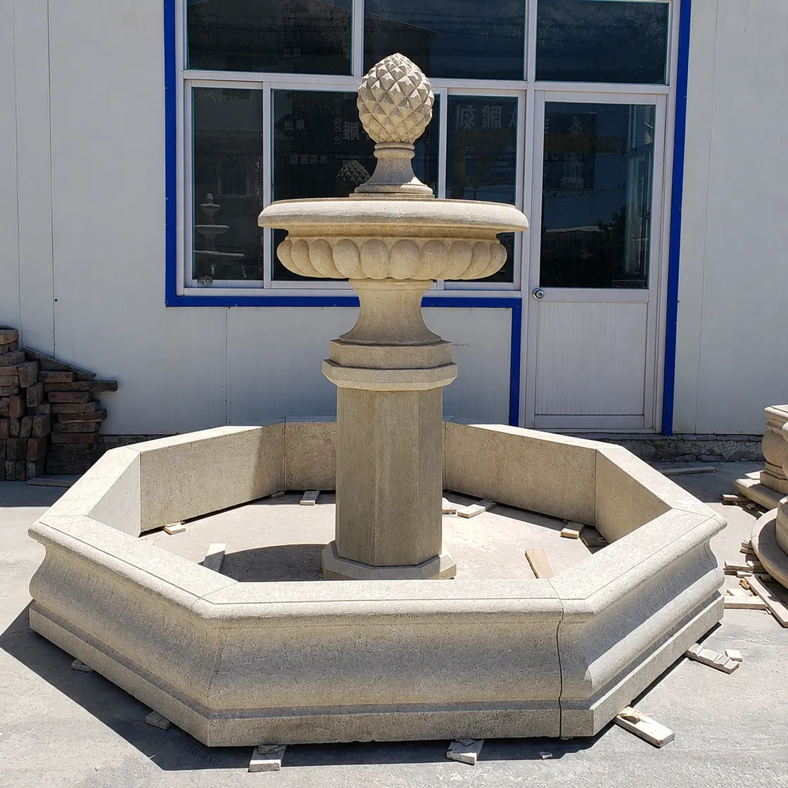 Compact natural stone fountain with octagonal basin and carved center pedestal