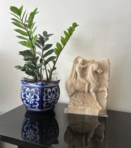 Custom Greek horseman marble relief displayed indoors after delivery to a U.S. client