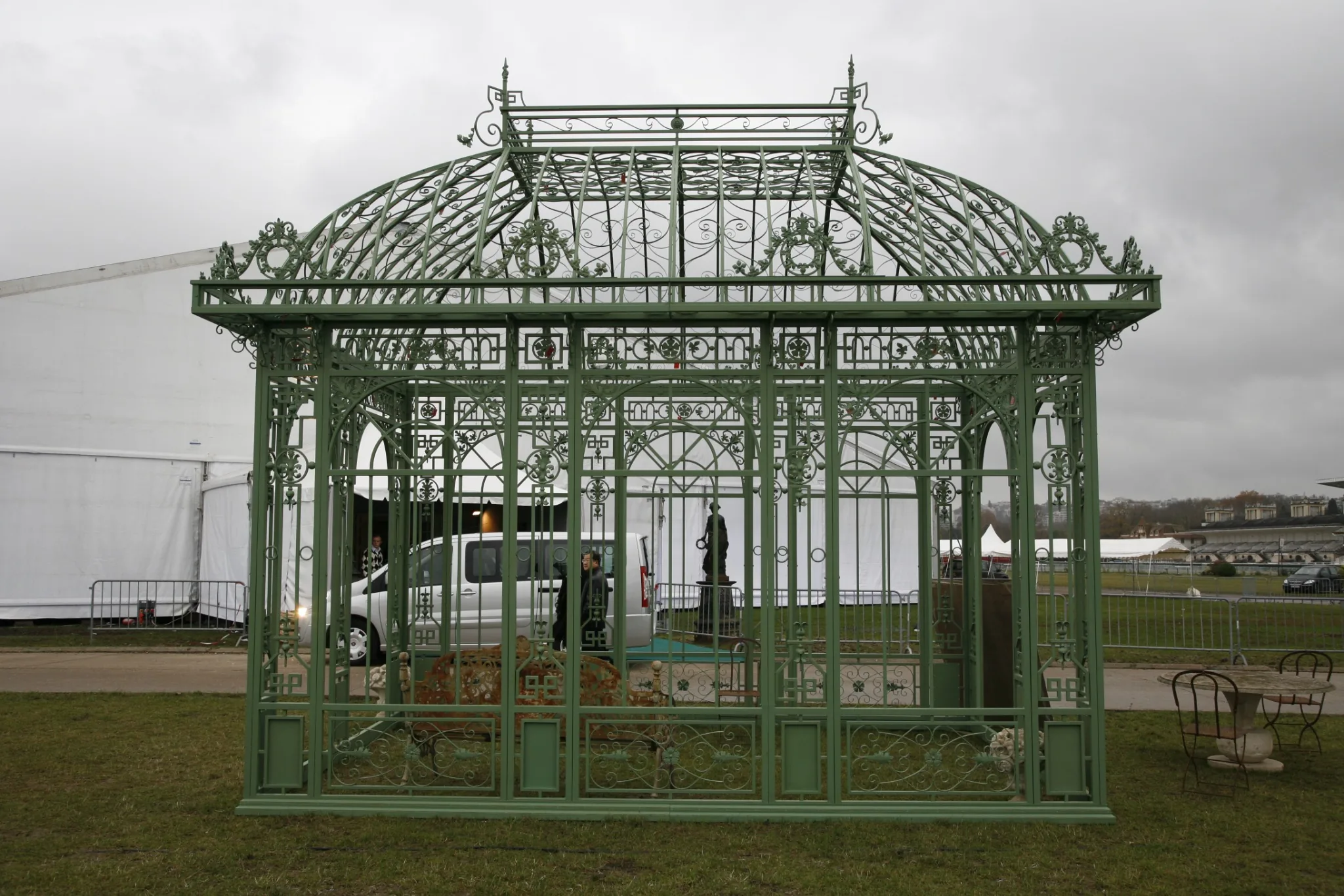 Green ornate open-air wrought iron gazebo shown as a style reference
