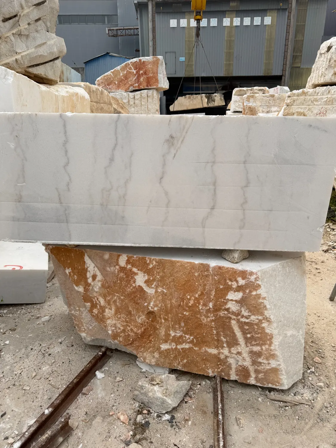 Large pale natural stone block at the carving factory before cutting