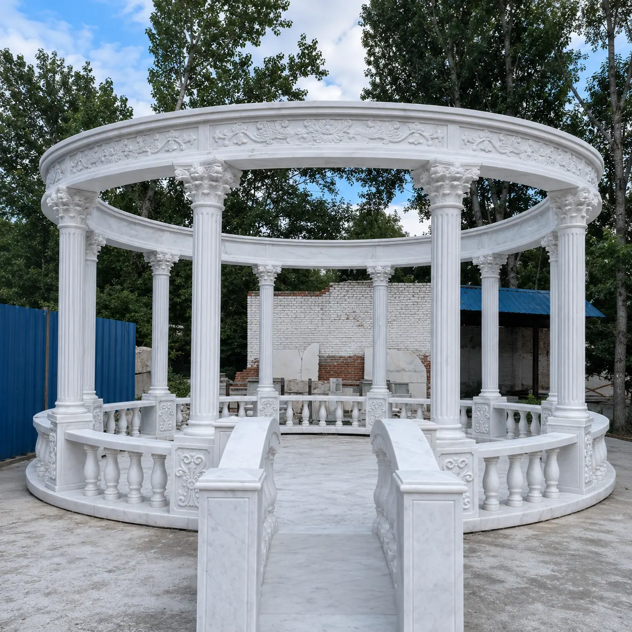 Large open-top white marble wedding gazebo with classical columns and a wide entrance