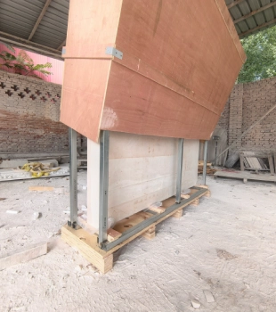 Large marble relief secured with protective framing for international shipping