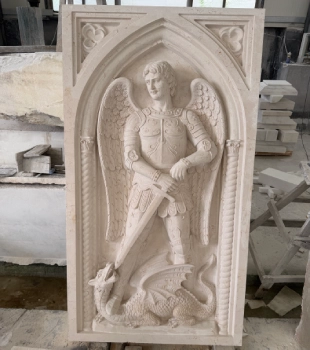 St. Michael marble relief during the stone carving and detail refinement stage