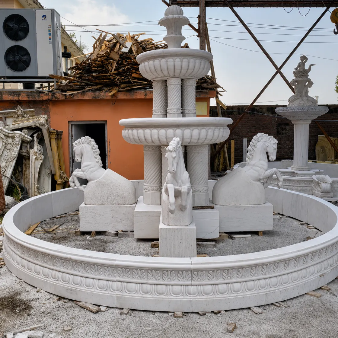 White marble tiered fountain with carved lions around its center and a wide basin