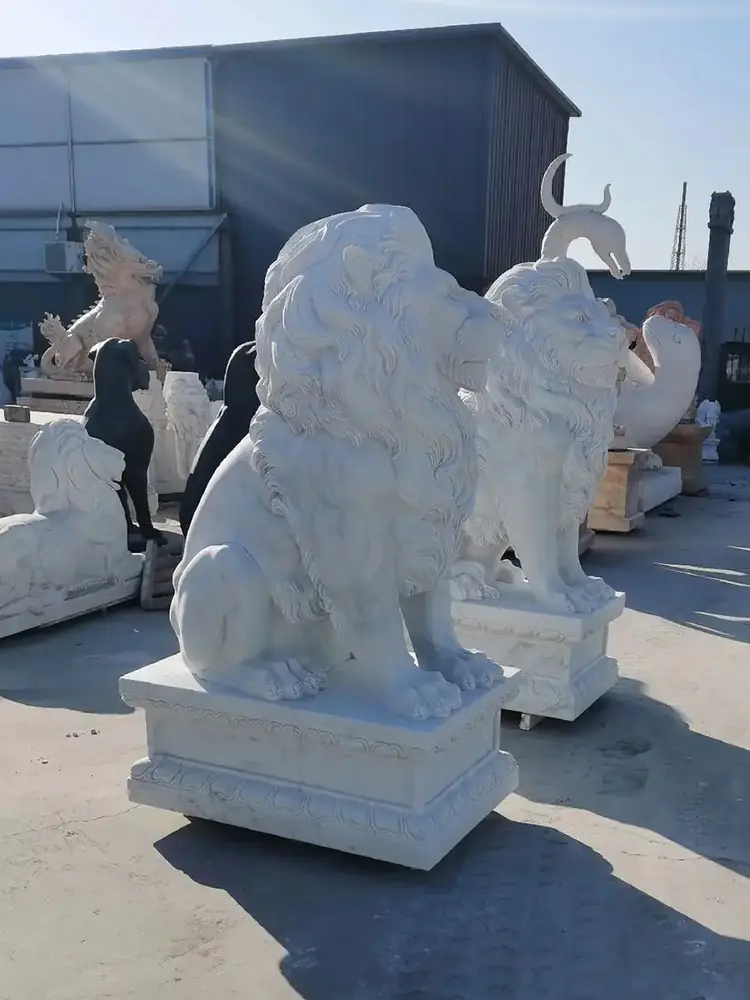 Pair of white marble sitting lion statues for a modern entrance