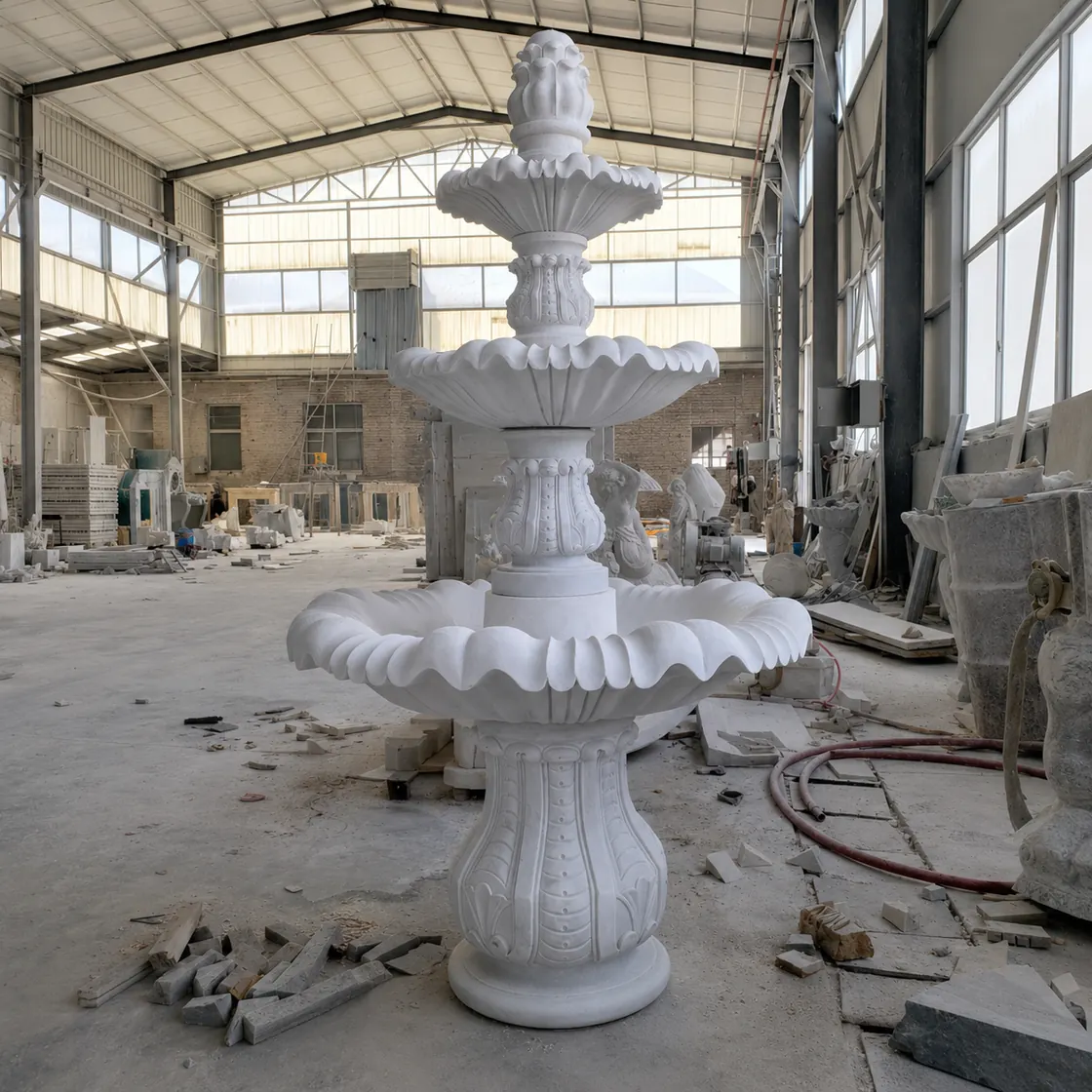 White marble tiered garden fountain photographed in the Yun Sculpture workshop